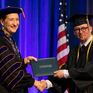 Student with chancellor at commencement