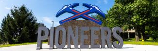 sign on campus with large Pioneer and pickaxes