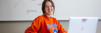 smiling UW-Platteville mathematics student sits in classroom