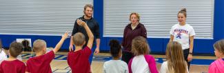 UW-Platteville HHP students work with group of children in gym