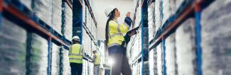 Professionals in the Supply Chain Management field review stock in warehouse