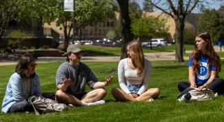 UW-Platteville sit outside in the grass for class discussion