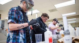 Three focused UW-Platteville students work in Plastics Lab