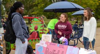 UW-Platteville students talking about their ministry club at the involvement fair