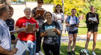 Smiling UW-Platteville students attend Spanish class outside on sunny warm day