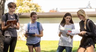 UW-Platteville students work outsides on a sunny day in small discussion groups