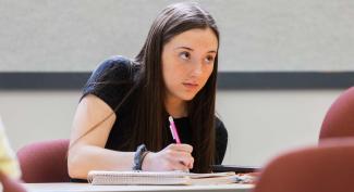 UW-Platteville student in class listening intently and taking notes