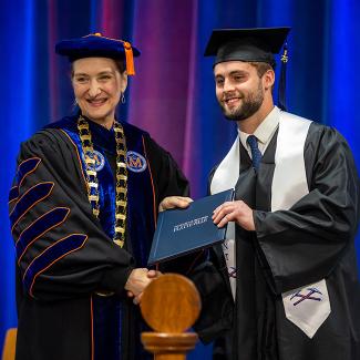 UW-Platteville student receiving diploma from Chancellor Evetovich