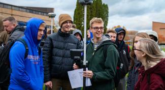 A group of environmental engineering students gathered on UW-Platteville campus grounds for a lab.