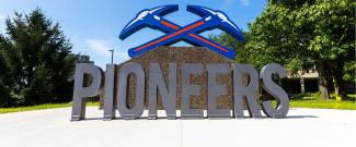 Large Pioneers with Pickaxe logo on top installed at UW-Platteville campus.