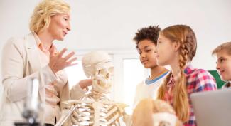 Young students learning biology from professor