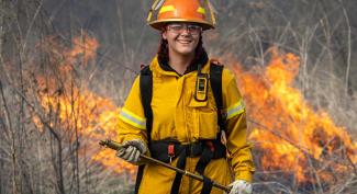 UW-Platteville student smiles while assisting with controlled burn