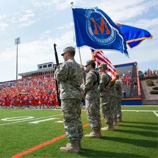 Line of veterans stand at attention at UW-Platteville football game