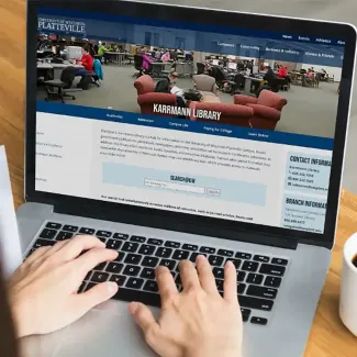 Student using laptop to access UW-Platteville website
