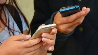 Two students using their phones.