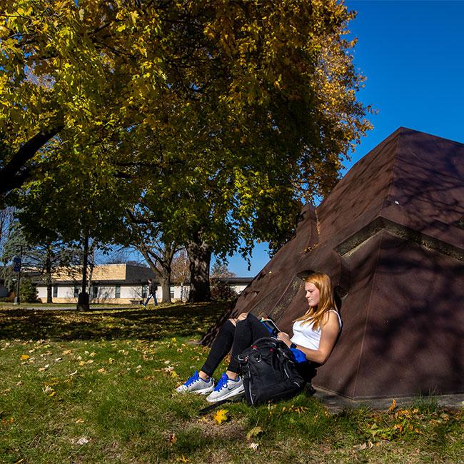 student relaxing on campus